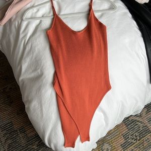 Rusty orange V-neck ribbed bodysuit with adjustable straps